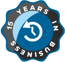 A circular badge with a light blue center featuring a white clock icon turning counterclockwise. The outer ring is dark blue with the text "15 YEARS IN BUSINESS" in white, with a black scalloped border accentuating the design.